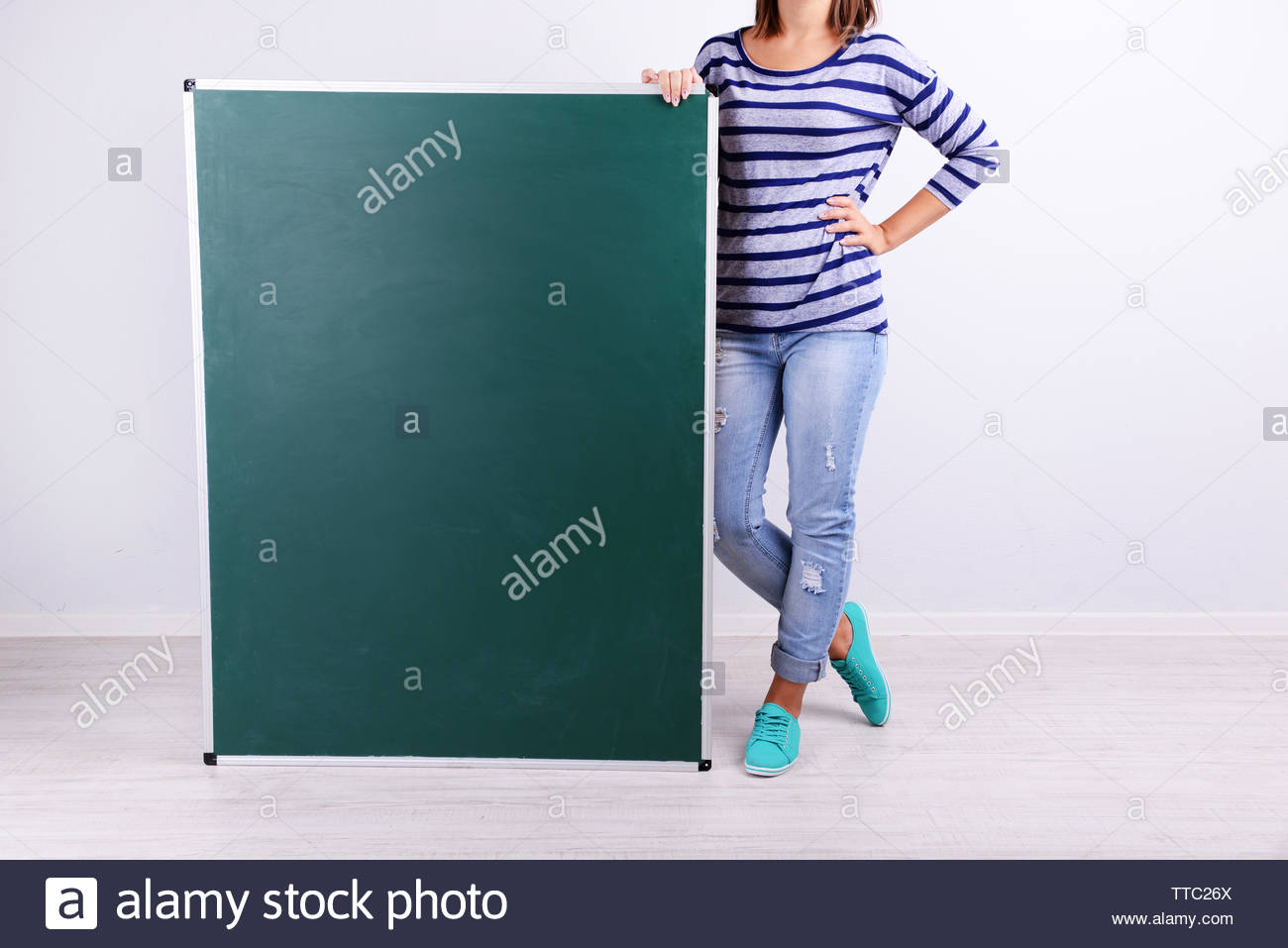 Woman In Causal With Green Blackboard On Grey Background Close Up