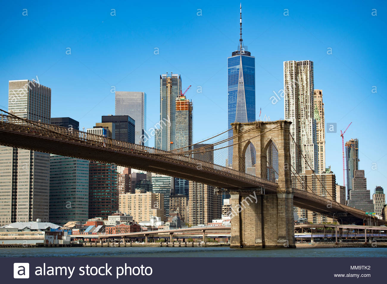 Manhattan Skyline With The Brooklyn Bridge And One World Trade
