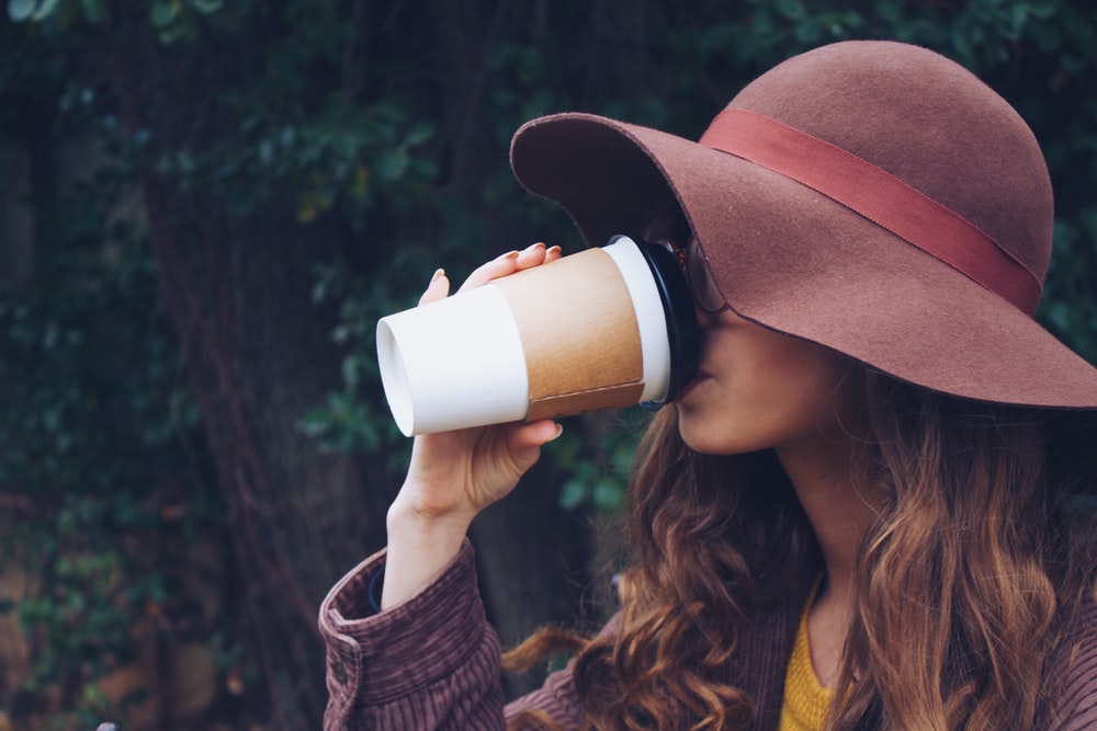 Woman Wearing Brown Hat Drinking Coffee Photo Image