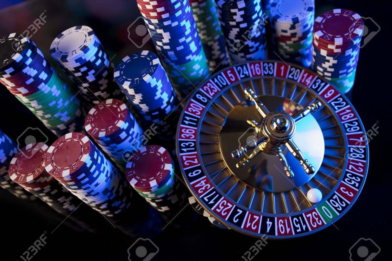 Casino Blurred Background Roulette And Stacks Of Chips Stock