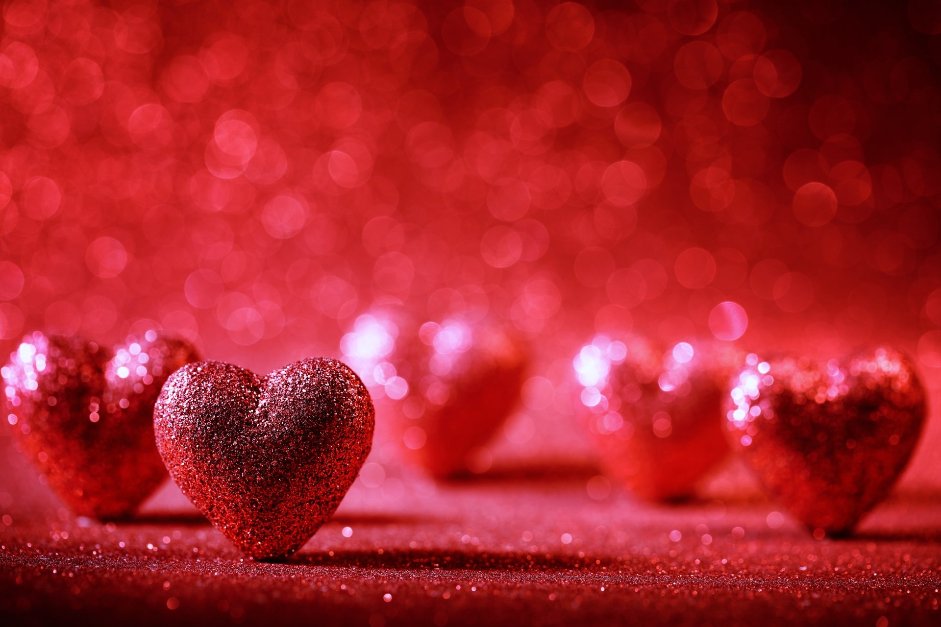 Glittering red hearts on a sparkly background, perfect for Valentine's Day