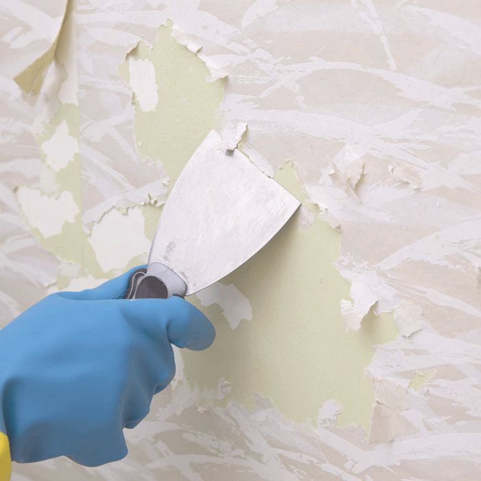 Scraping Wallpaper Off A Wall As Preparation For Tile Installation