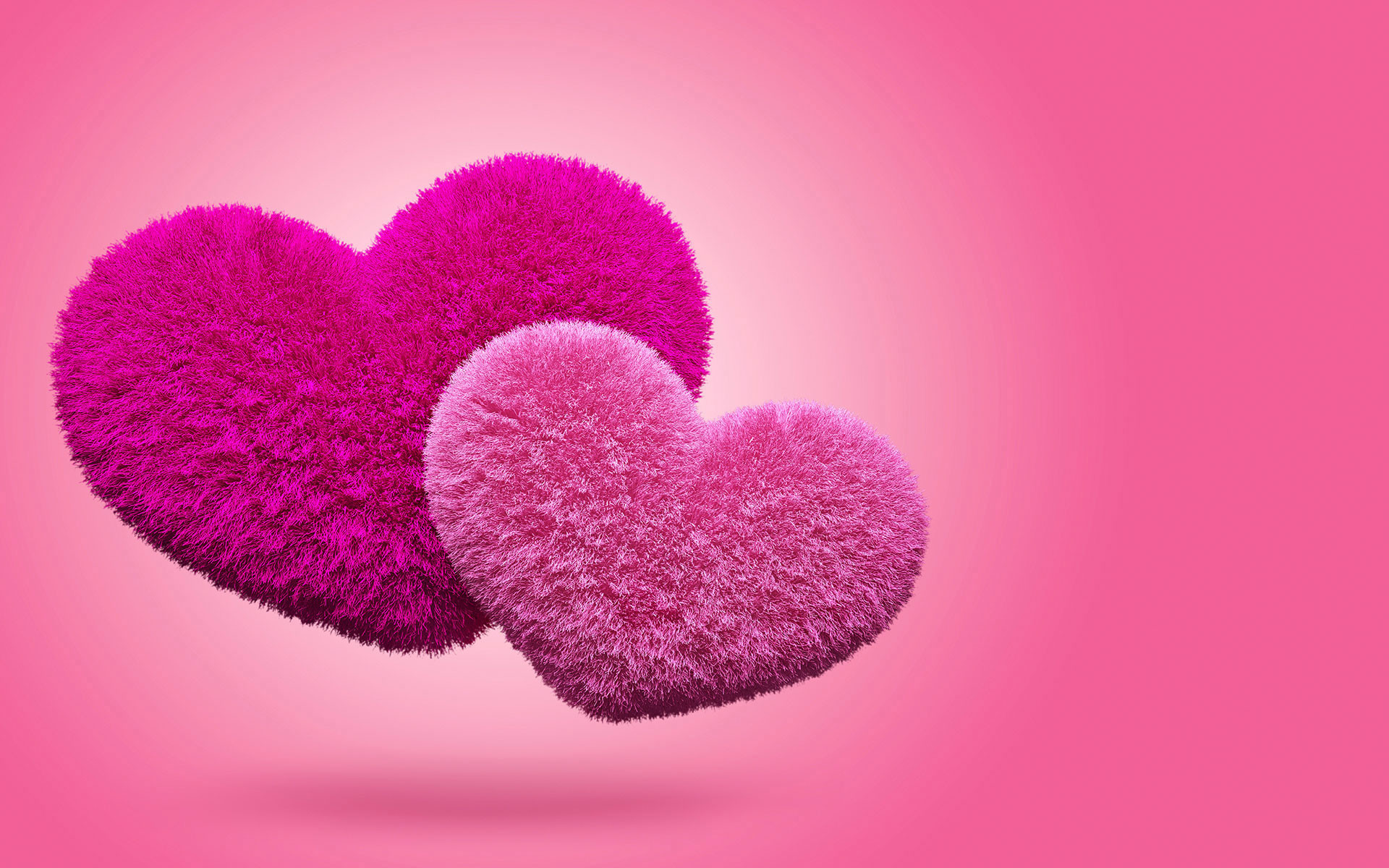 Two fluffy pink hearts on a pink background