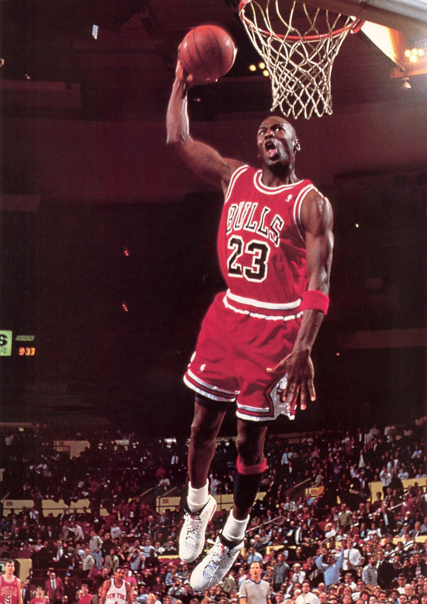 Michael Jordan performing a powerful dunk in a Chicago Bulls game, showcasing his iconic number 23 jersey