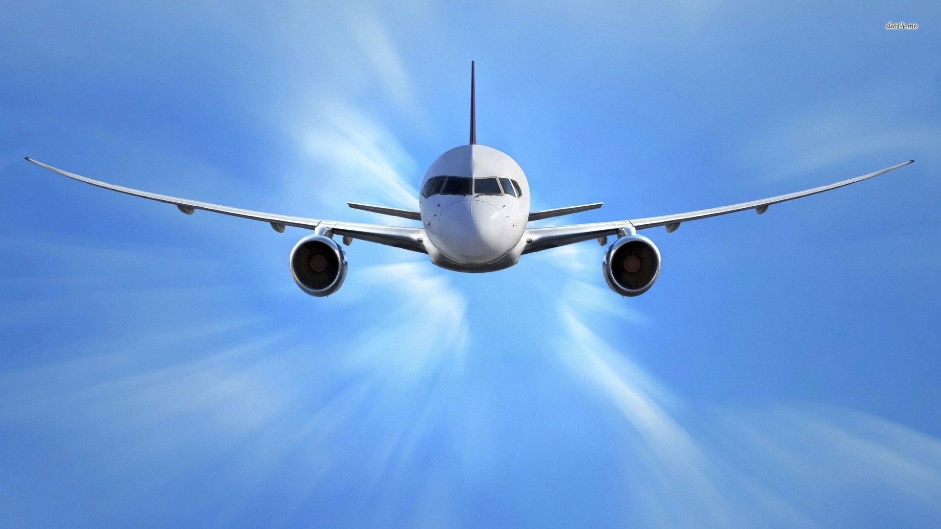 A passenger airplane soaring through the clear blue sky