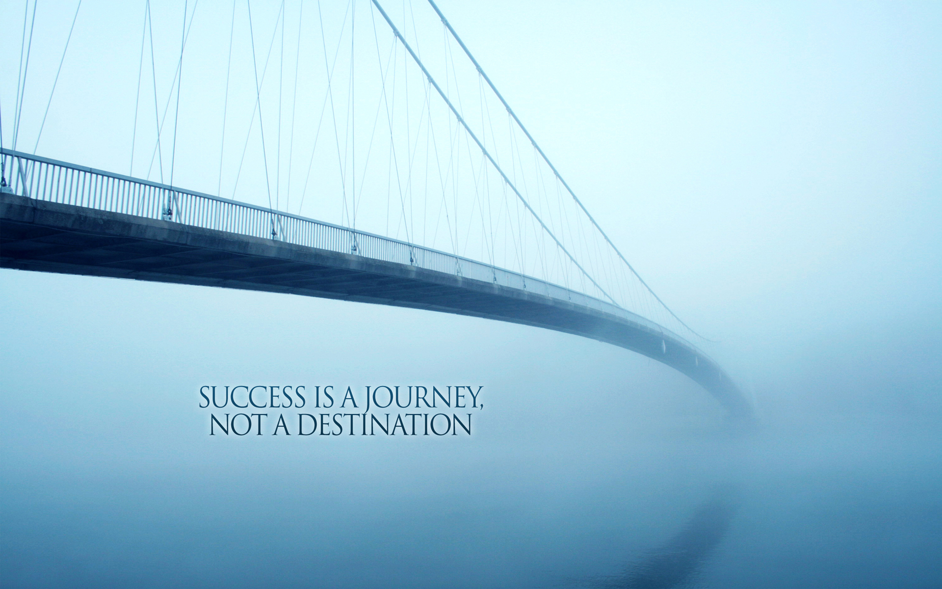 A suspension bridge disappearing into the fog, symbolizing the ongoing journey of success
