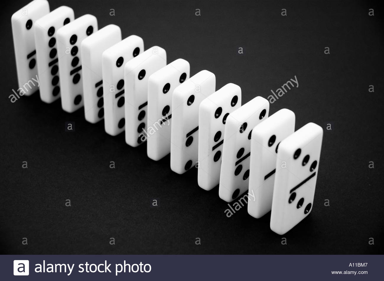Dominos in a row on a black background Stock Photo 5777798