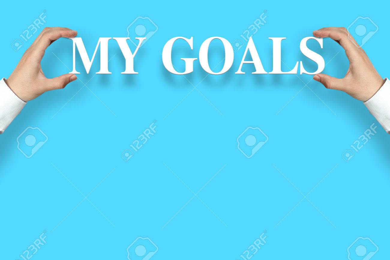 Businessman Is Holding The My Goals Text Against Blue