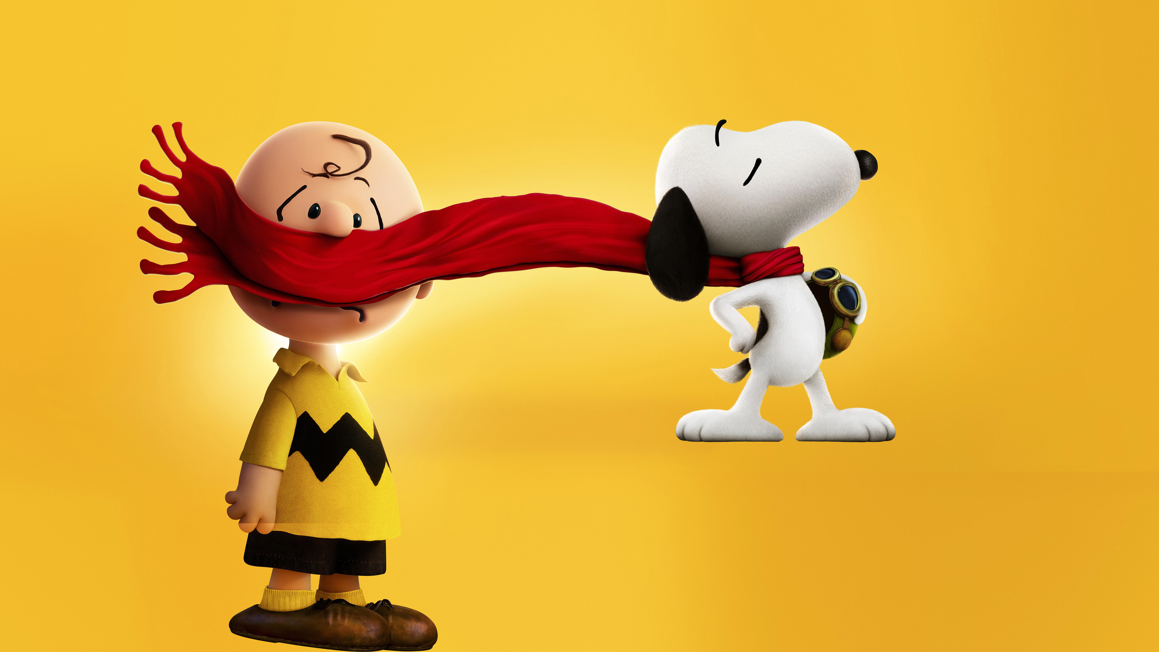 Snoopy pulls Charlie Brown's scarf in a funny scene from The Peanuts Movie, set against a vibrant yellow background