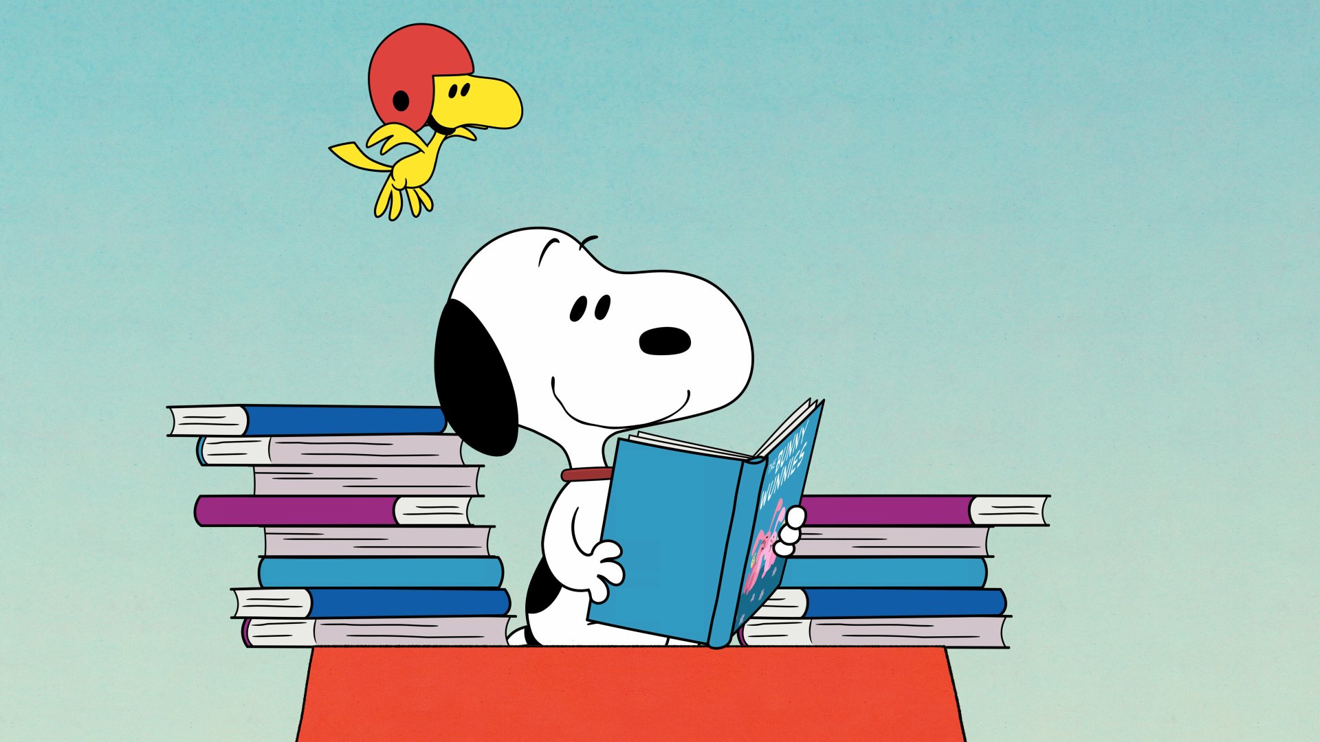 Snoopy joyfully reads a book, surrounded by a stack of books, with Woodstock hovering above, a perfect 4K wallpaper for Peanuts fans