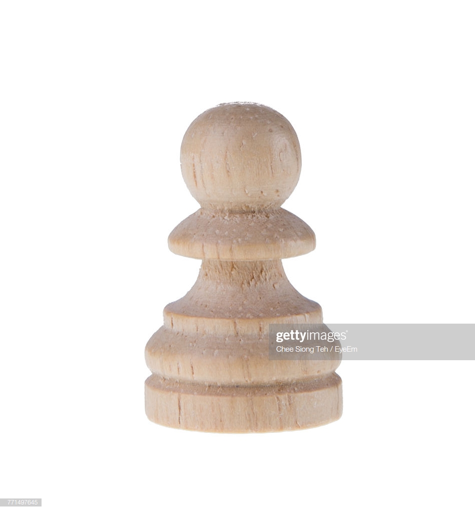 Closeup Of Wooden Pawn Against White Background Stock Photo