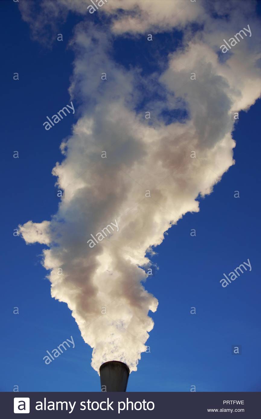 White Smoke Ing Out Of Industrial Chimney With Blue Sky