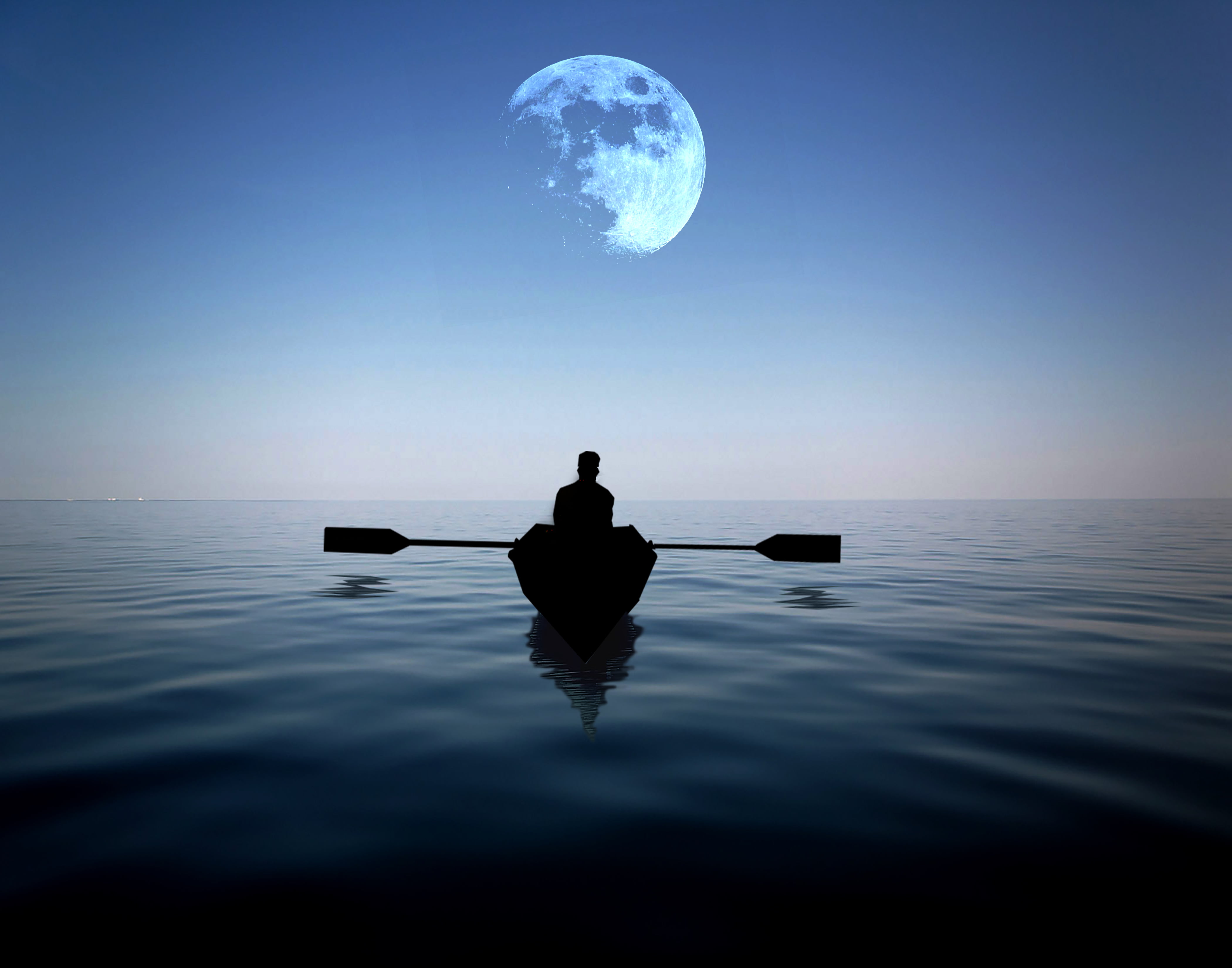 Man Riding On A Boat Alone In The Sea With Moon Hovering Above At