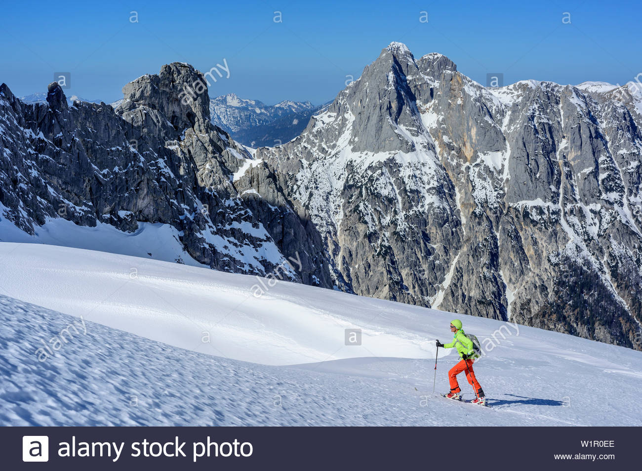 Free download Woman backcountry skiing ascending towards
