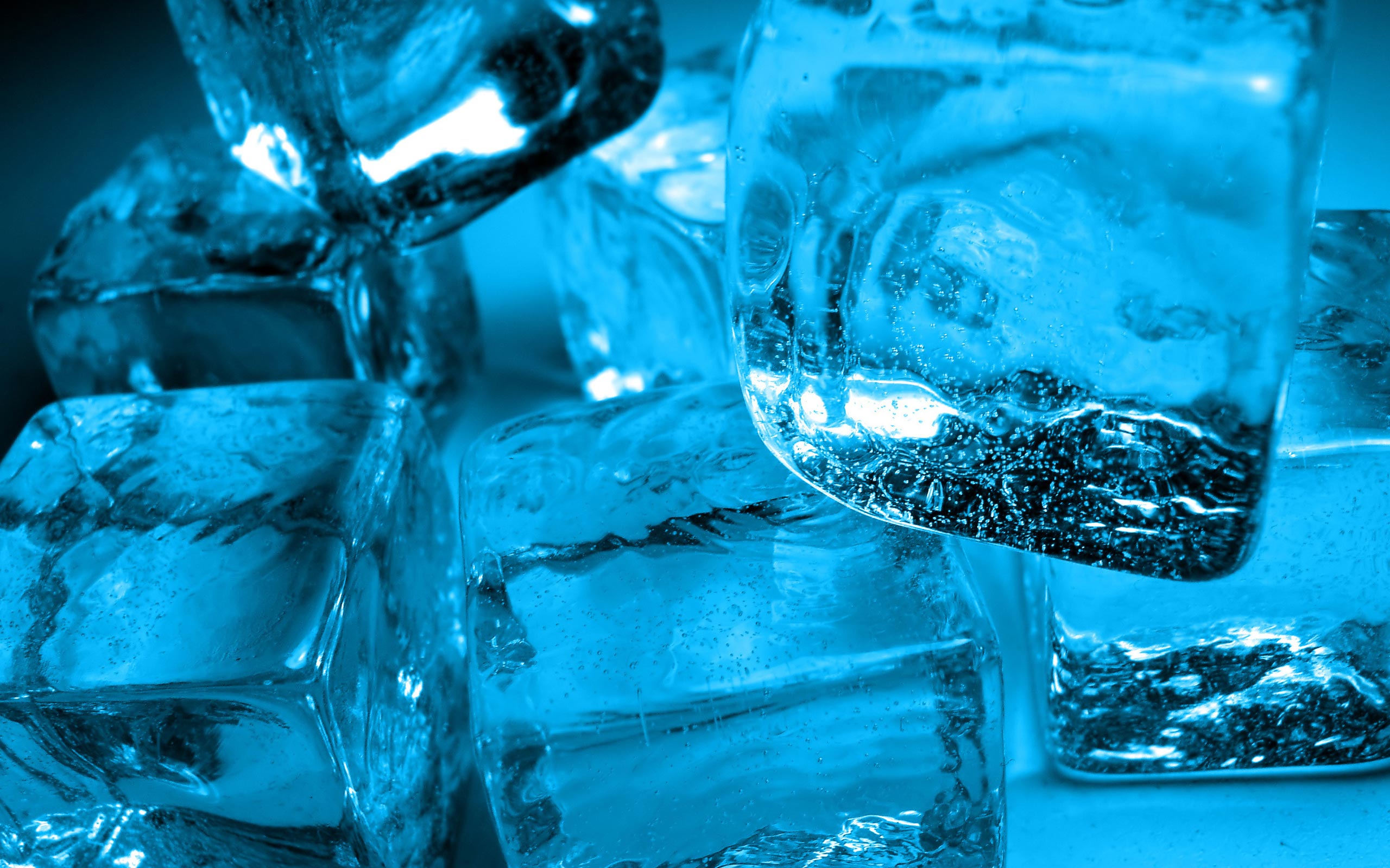 Close-up of glistening blue ice cubes, showcasing their texture and translucence