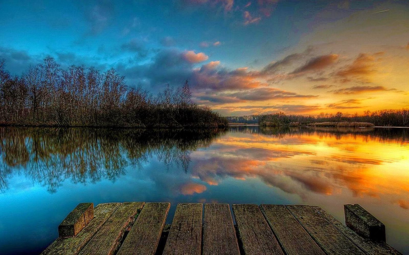 Sunset over a Serene Lake with Wooden Dock