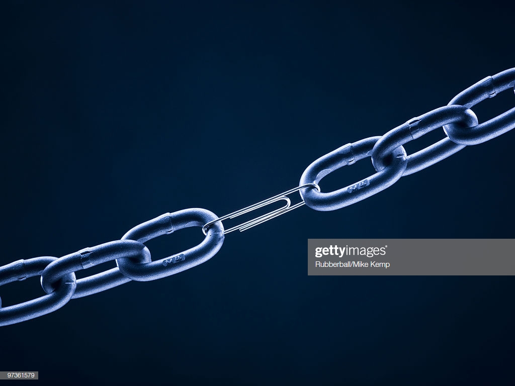 Chain Linked With Paper Clip Against Blue Background Stock Photo