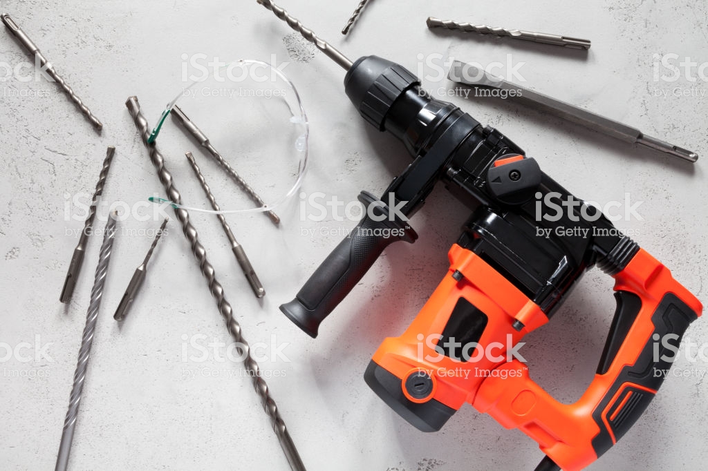 Close Up Of Electric Drill On Concrete Background Stock Photo