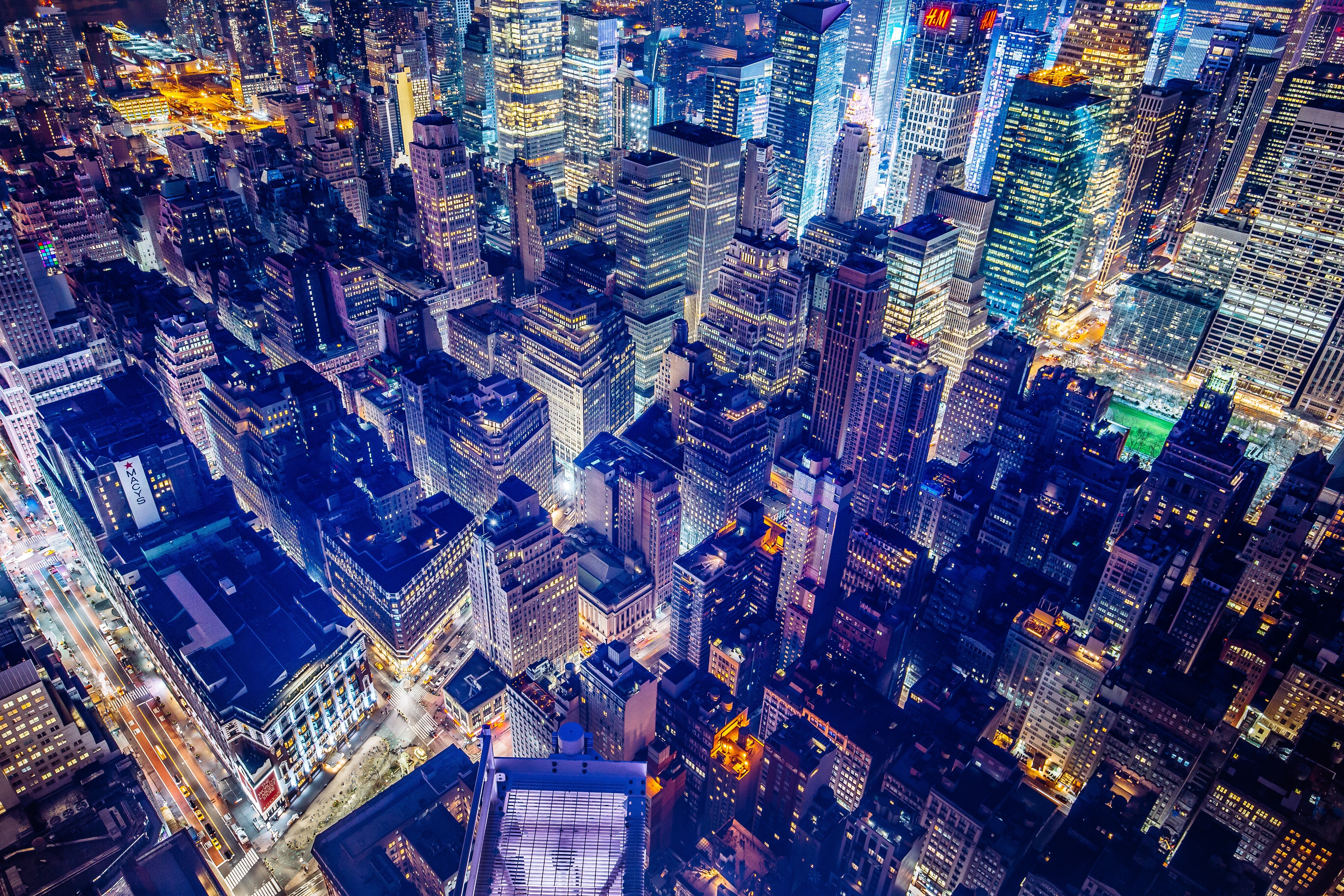 A breathtaking aerial view of Broadway in New York City at night, showcasing the dazzling lights and towering skyscrapers that make it the heart of the theater district