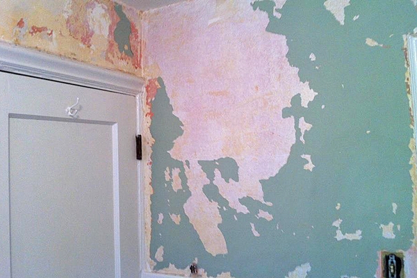Wetting Down The Wallpaper With A Mixture Of Remover Hot