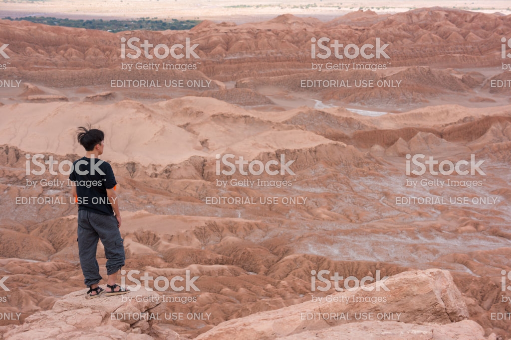 Single Person On Mountaintop Moon Valley In Background Stock Photo