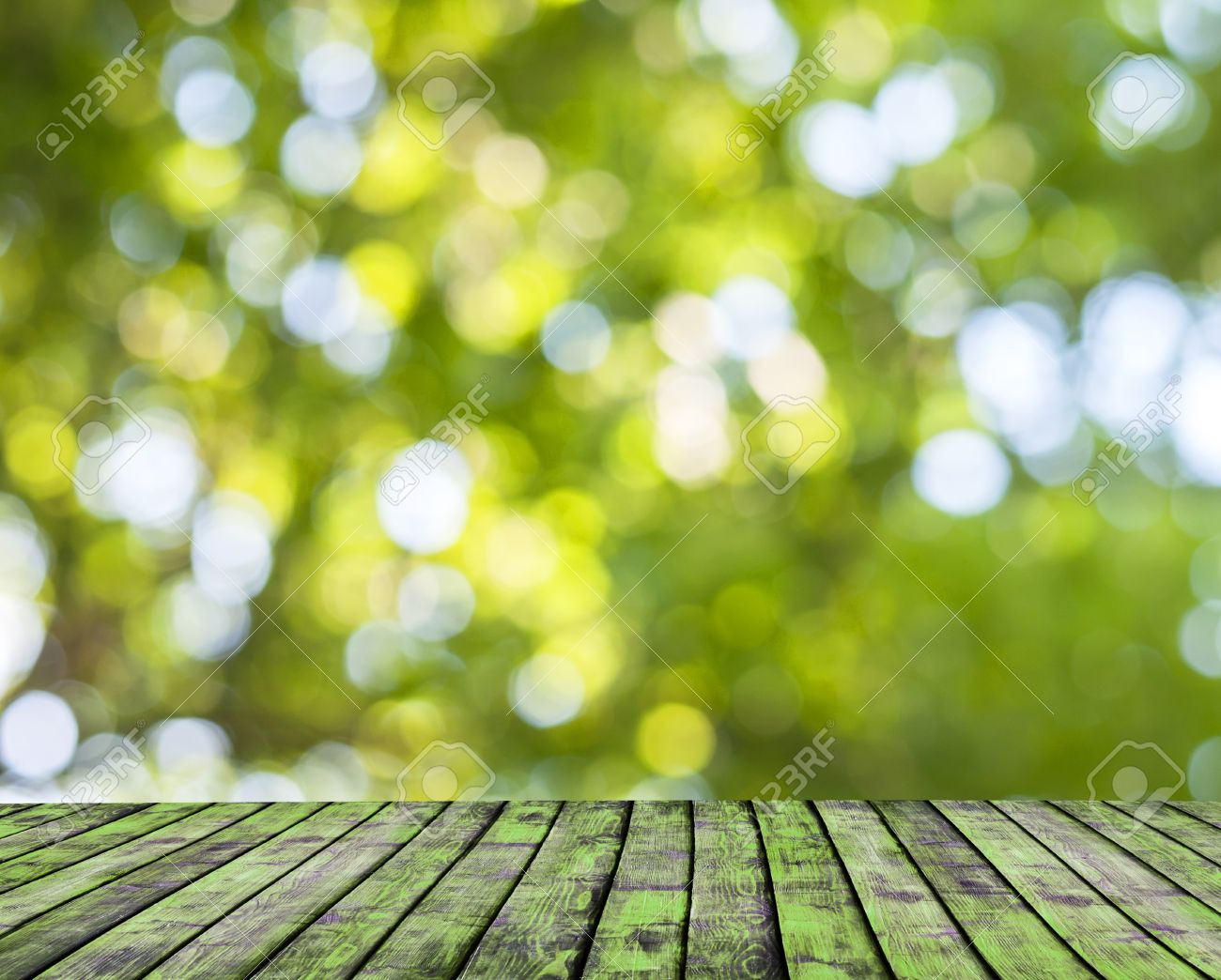 Wooden Floor And Green Forest Bokeh Blur Background Stock Photo