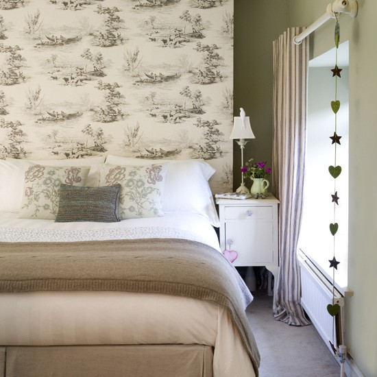 The toile wallpaper gives this room a classic French feel while the