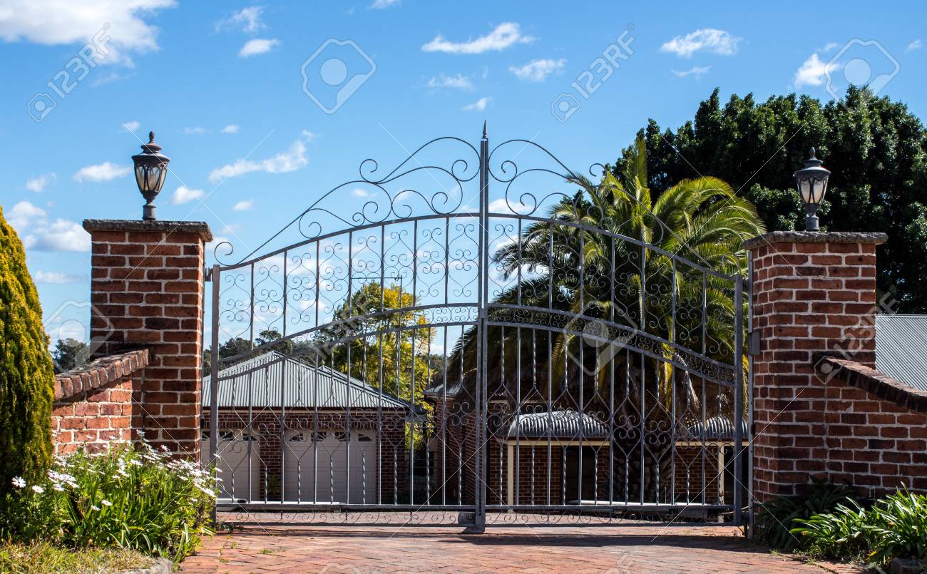 Metal Driveway Security Entrance Gates Set In Brick Fence With