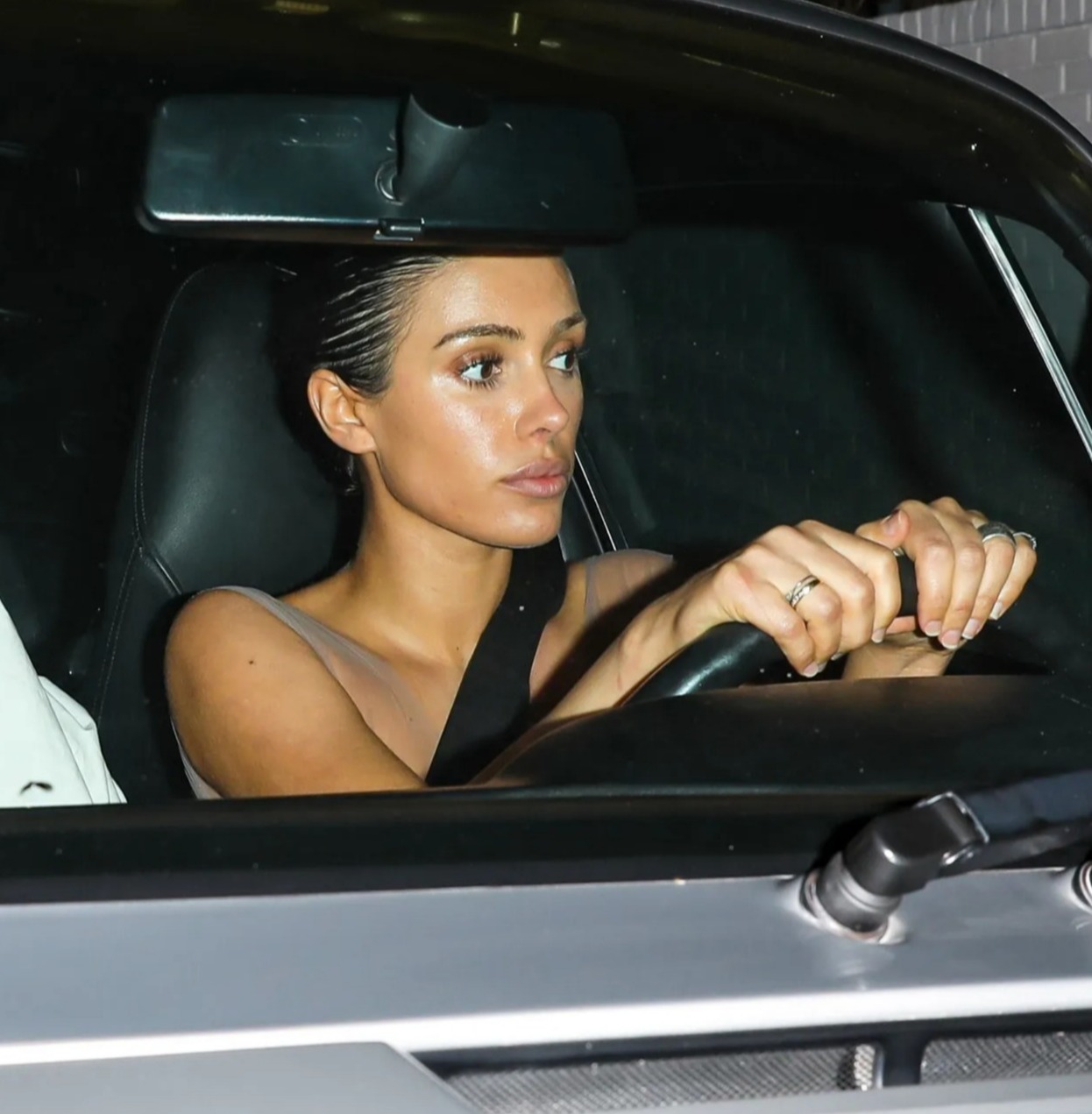 Bianca Censori driving a car at night