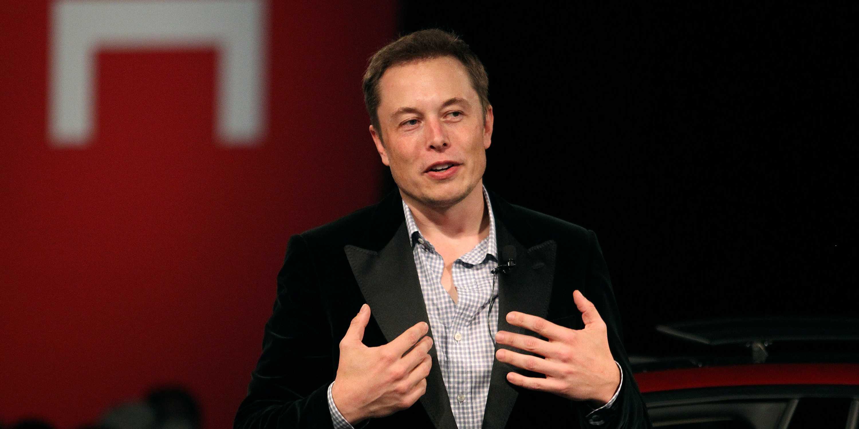 Elon Musk speaking at a Tesla event
