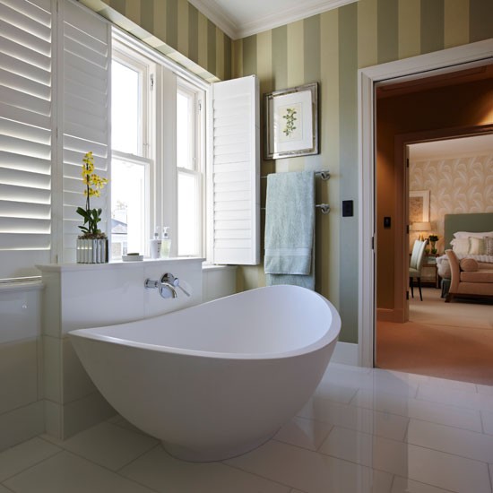White en suite bathroom with green stripe wallpaper 550x550