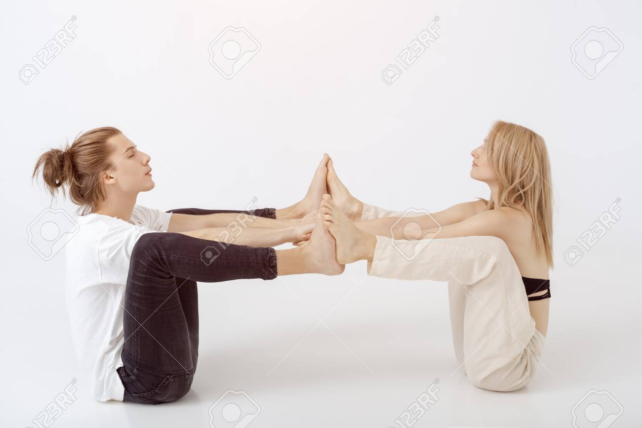 Young Athletic Couple Practicing Acroyoga Balancing In Pair