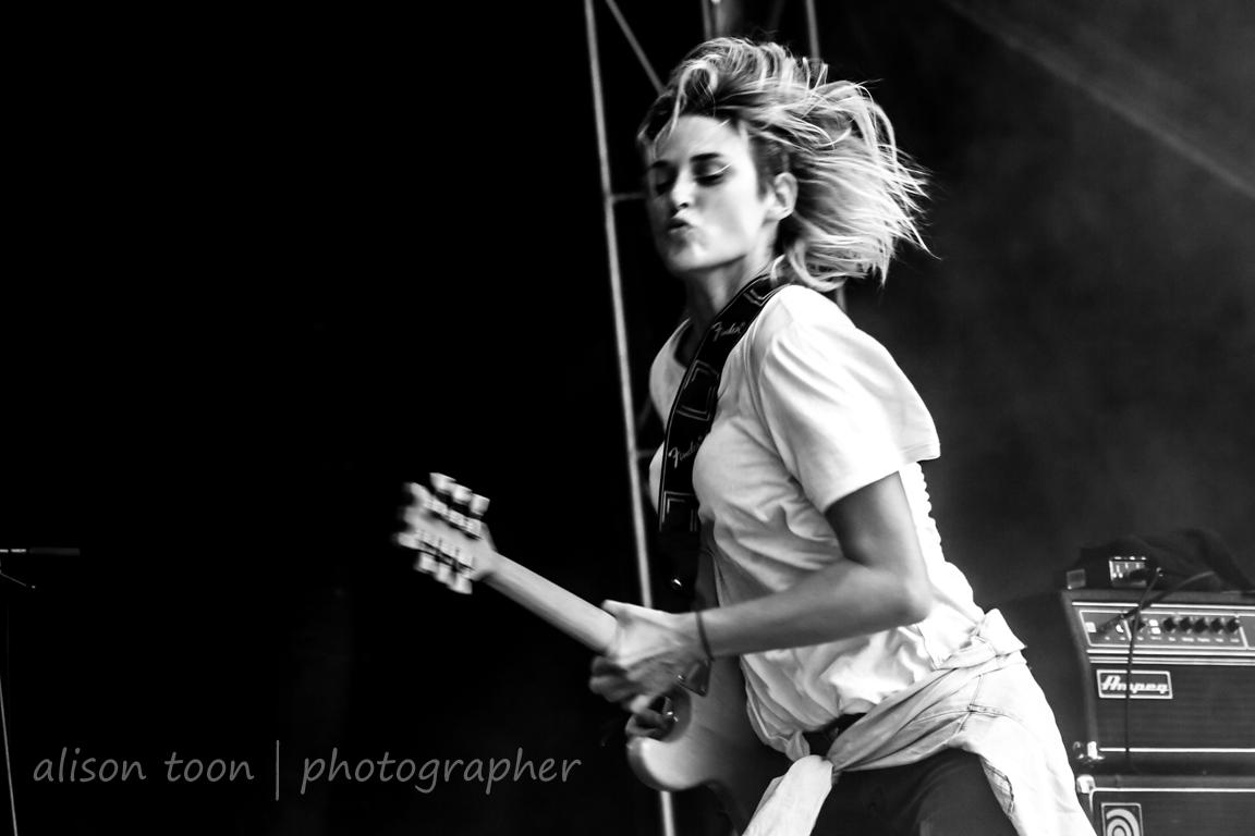 Emily Armstrong, lead singer of Dead Sara, performing live on stage with her guitar