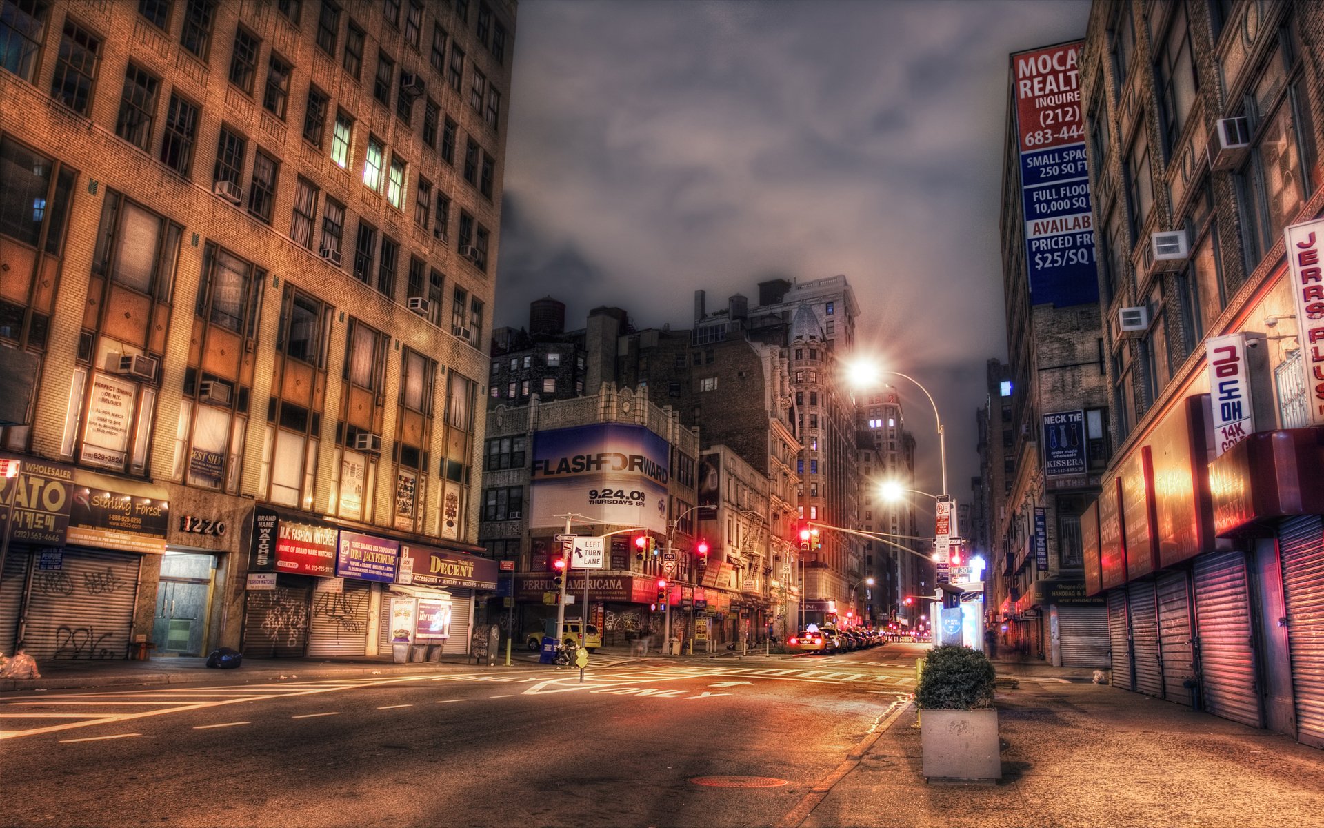 A vibrant night view of Broadway in New York City, illuminated by streetlights and neon signs, showcasing the bustling atmosphere and urban architecture