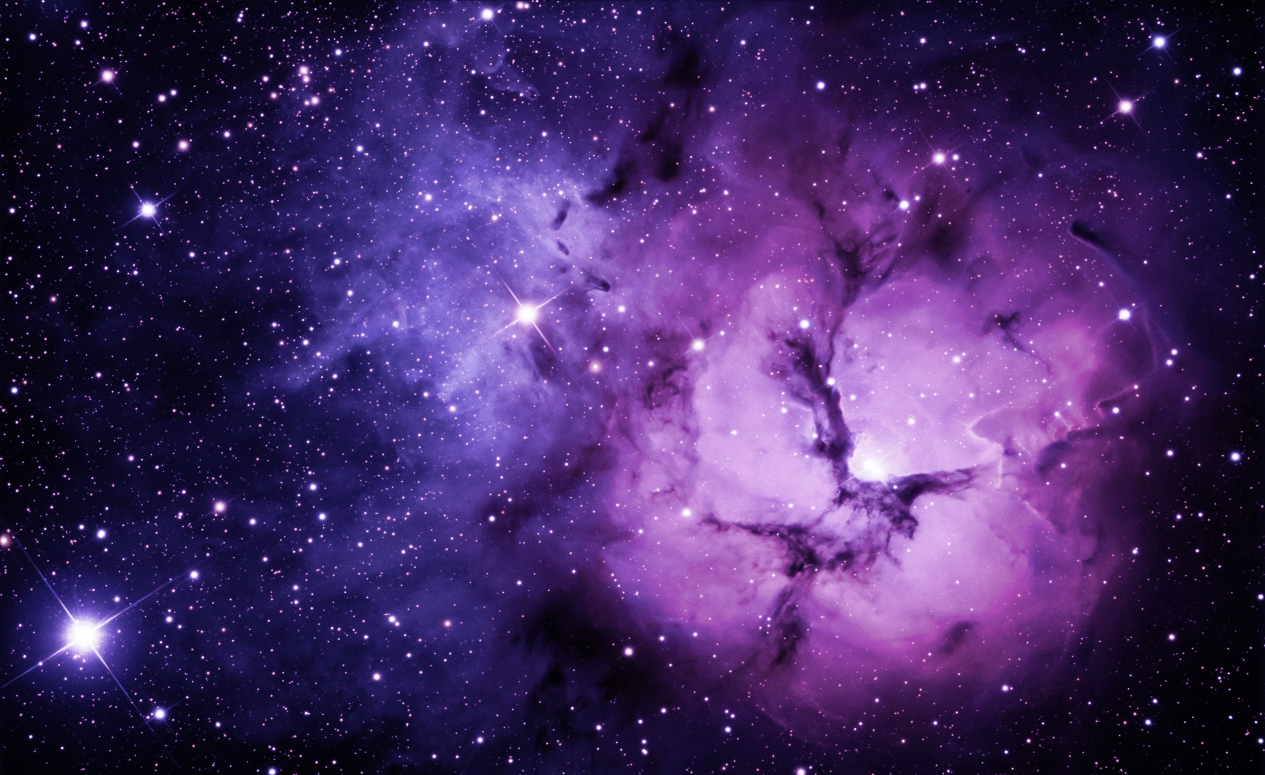 A breathtaking purple galaxy nebula wallpaper, ideal for desktop backgrounds. Cosmic dust and bright stars create a stunning interstellar scene