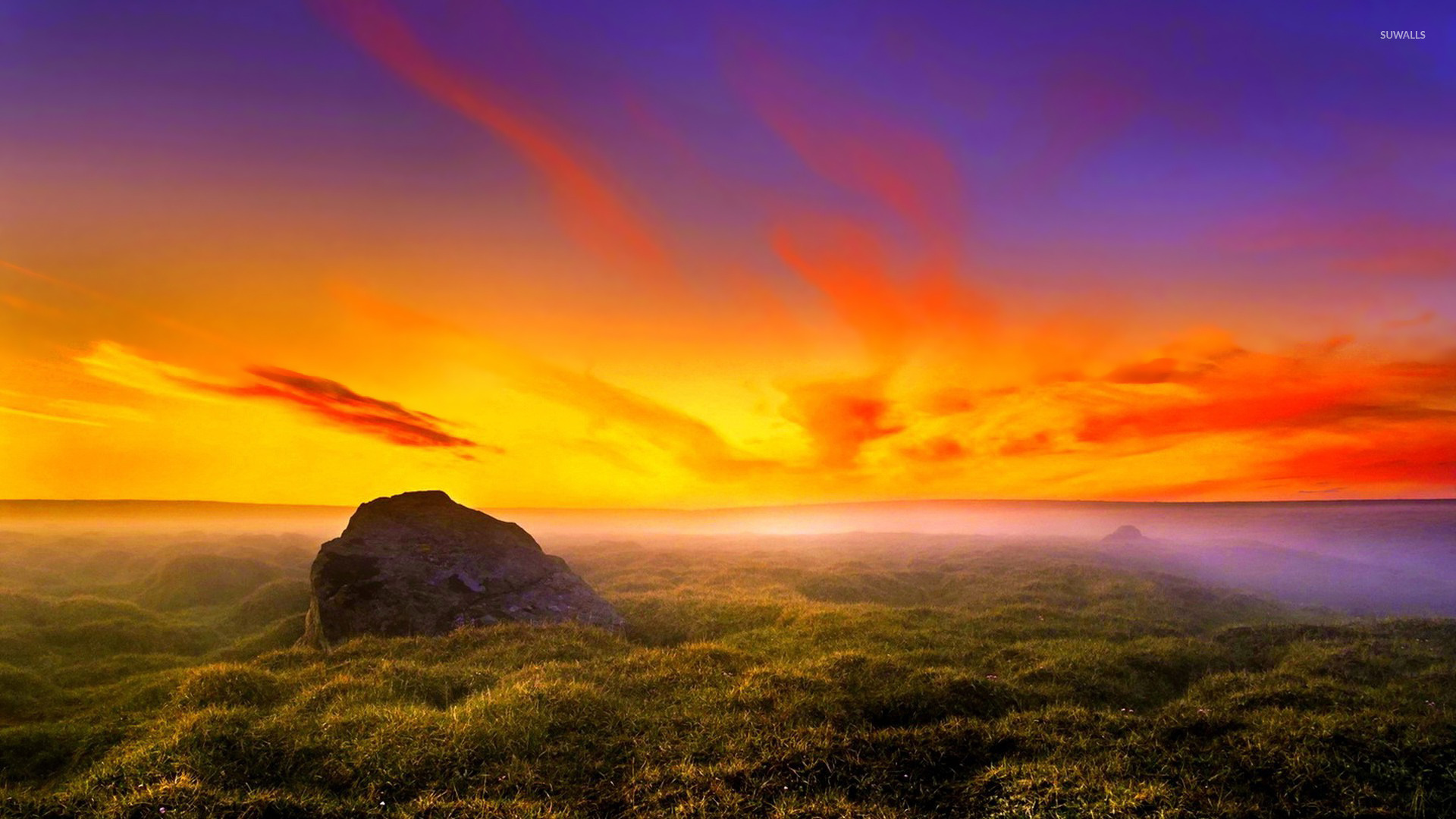 Rock Rising From The Grass To Gorgeous Sunset Wallpaper
