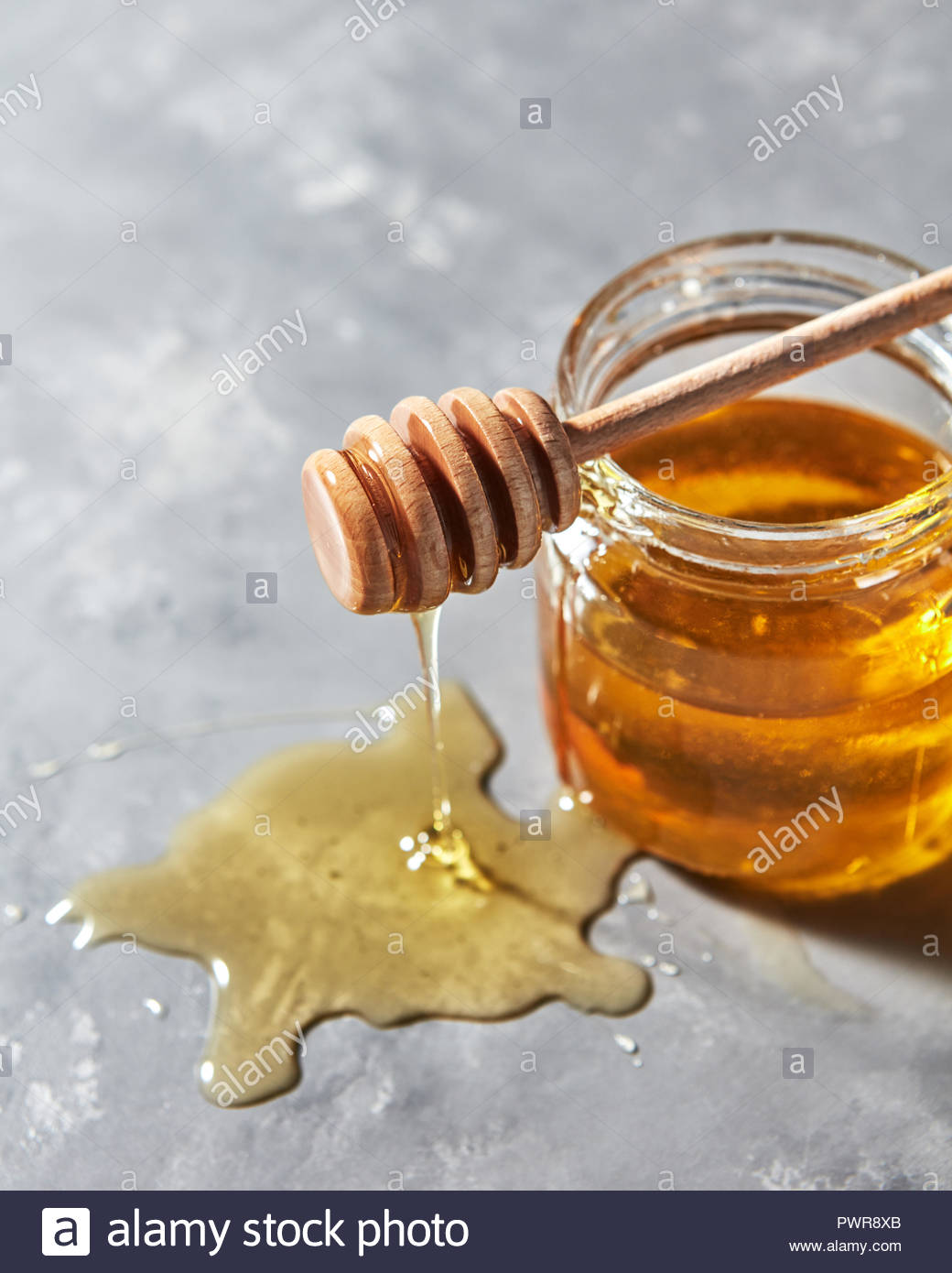 Dripping Sweet Honey Into A Puddle Of Fresh Organic Syrup On