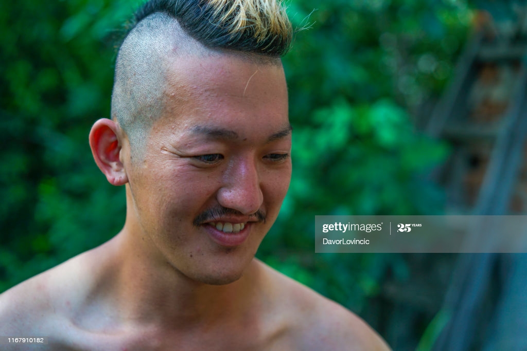 Portrait Of Japanese Man With Iroquois Like Hair Style And Blurred