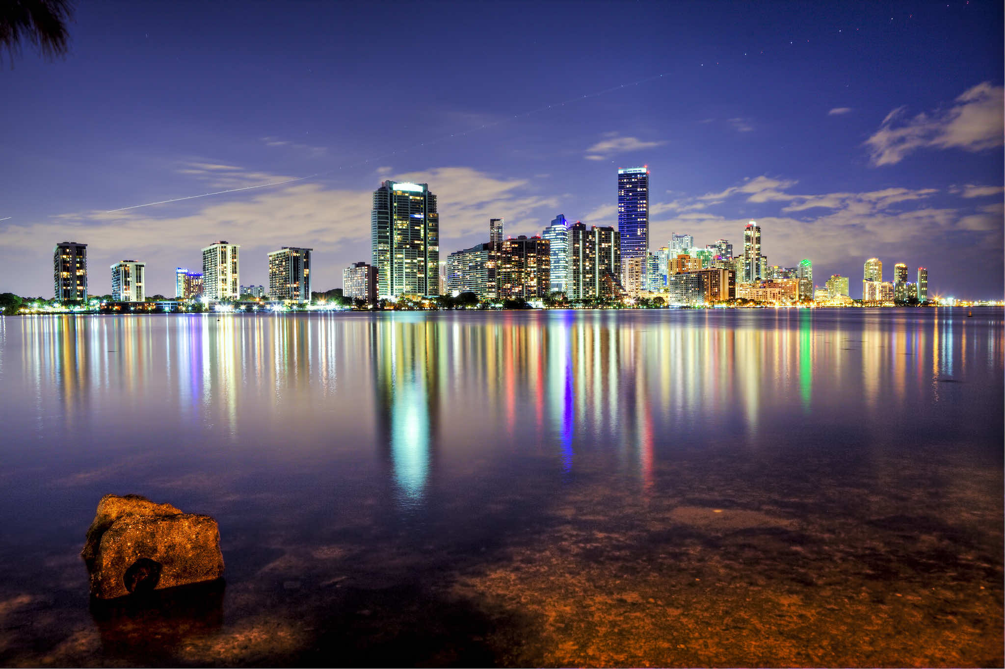 Stunning night view of the Miami skyline reflected in the calm waters of Biscayne Bay