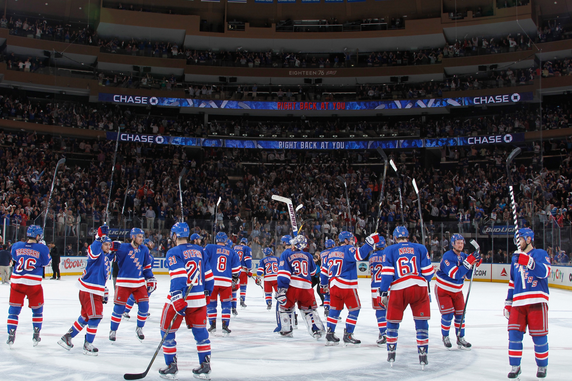 New York Rangers players celebrating a victory on the ice at Madison Square Garden