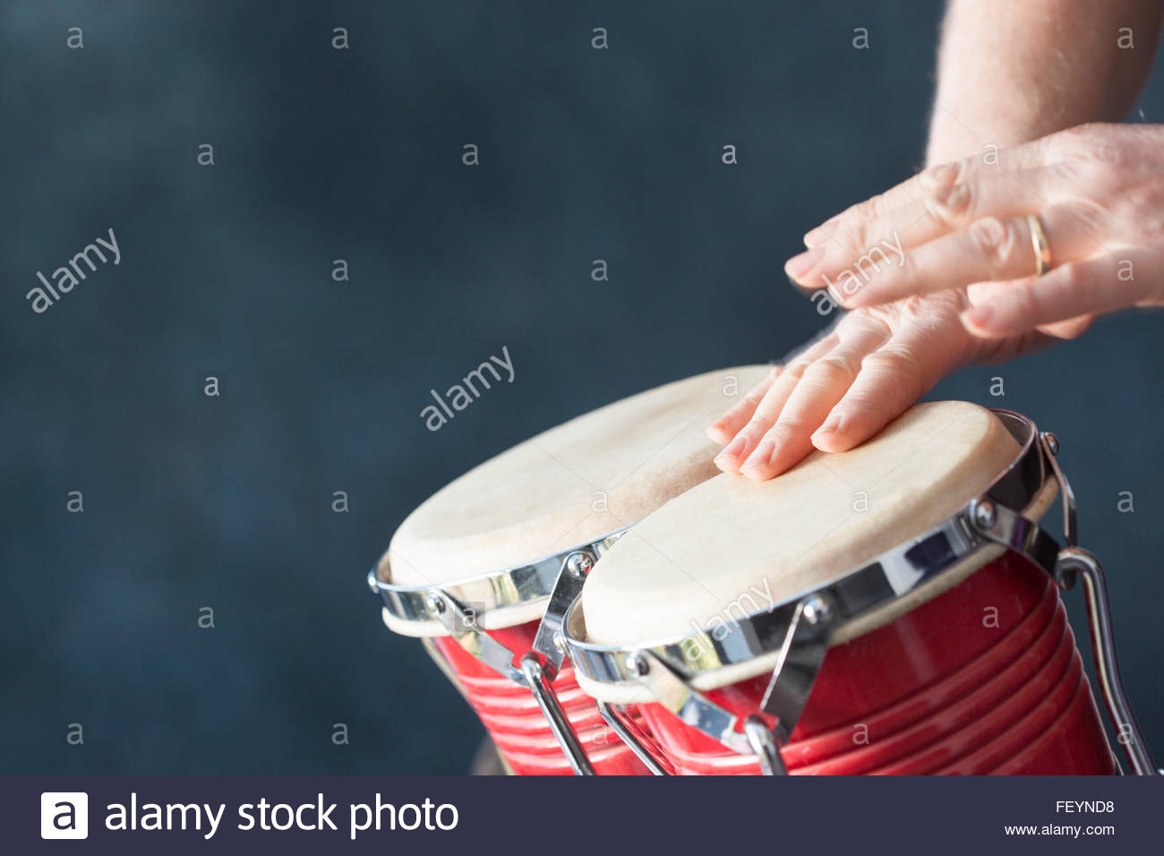 Free download Hands playing red bongo drums with a grey background Stock Photo [1300x956] for