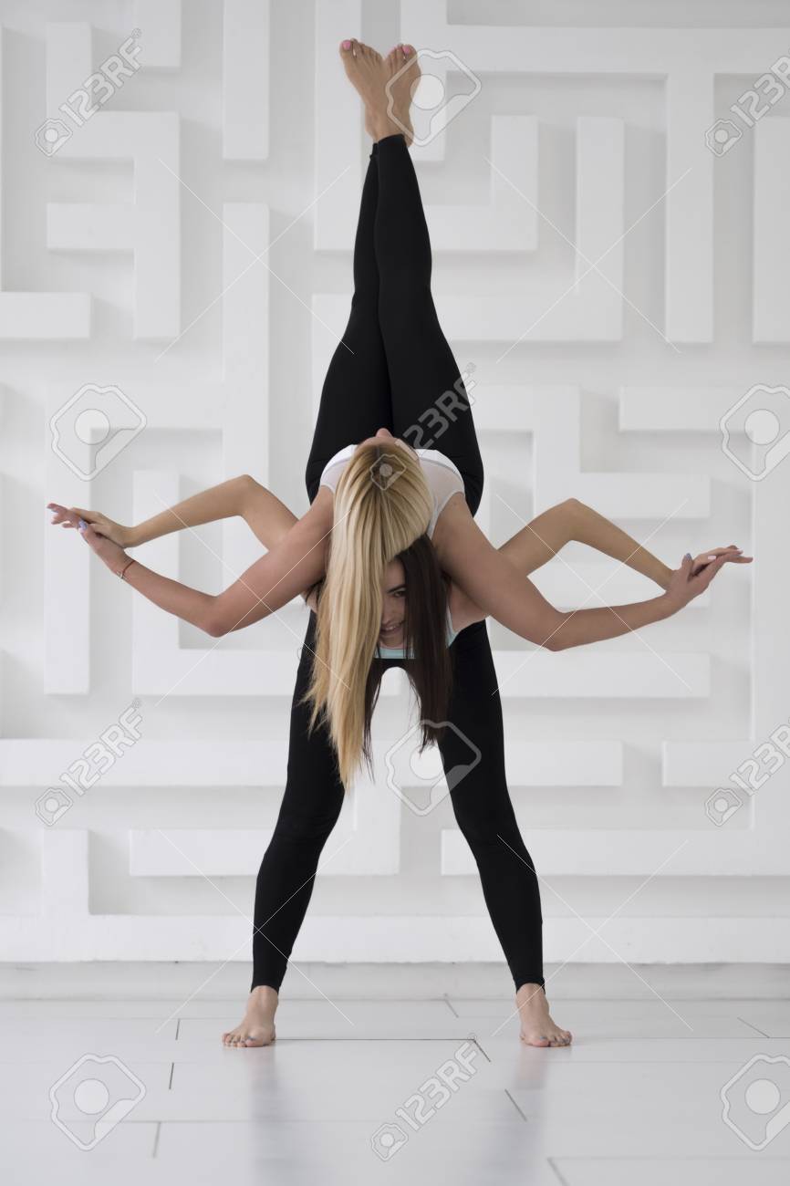 Two Young Girls Practicing Acro Yoga Balance Pose Black