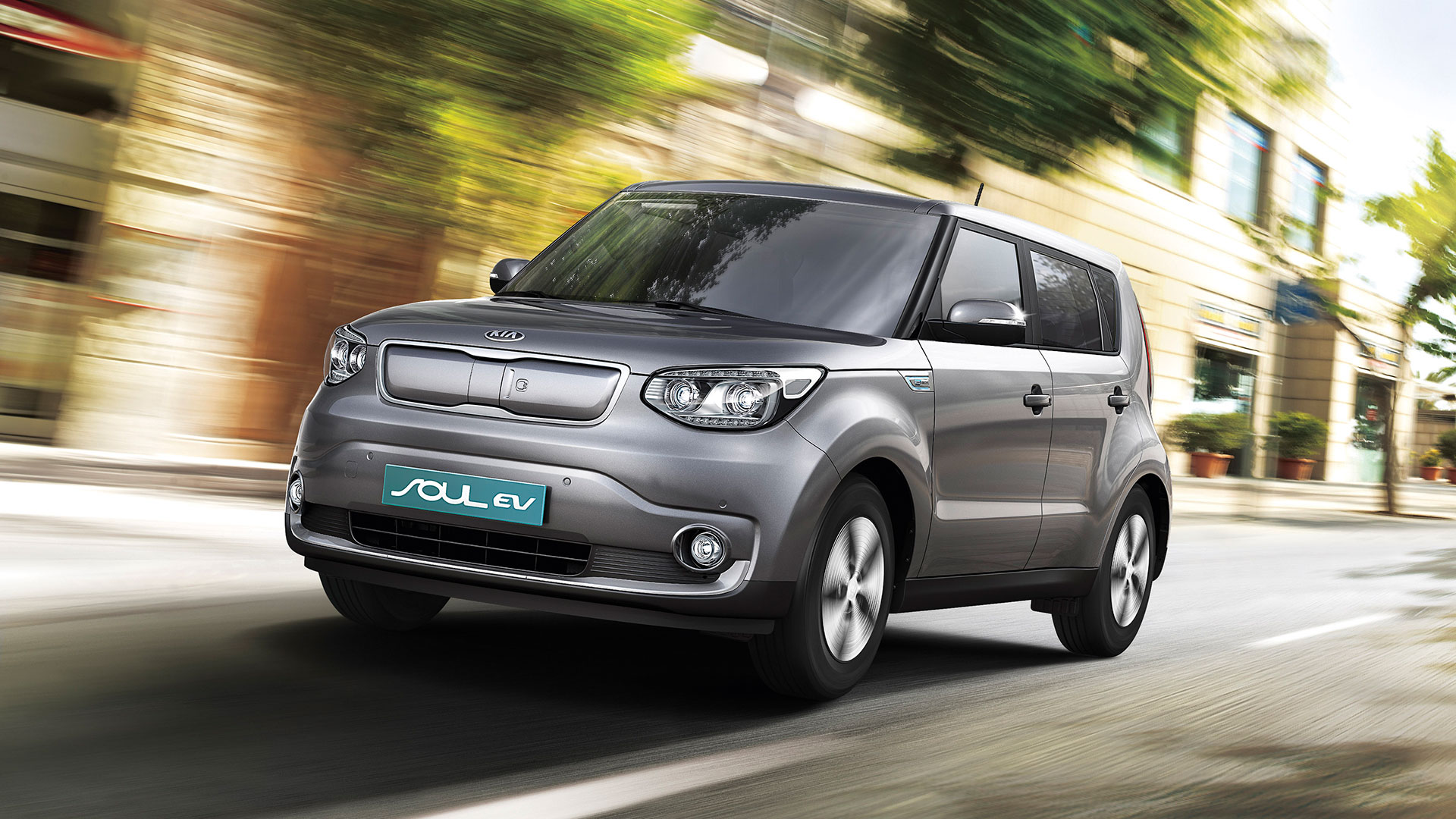 Silver Kia Soul Ev Electric Vehicle In Motion Wallpaper And