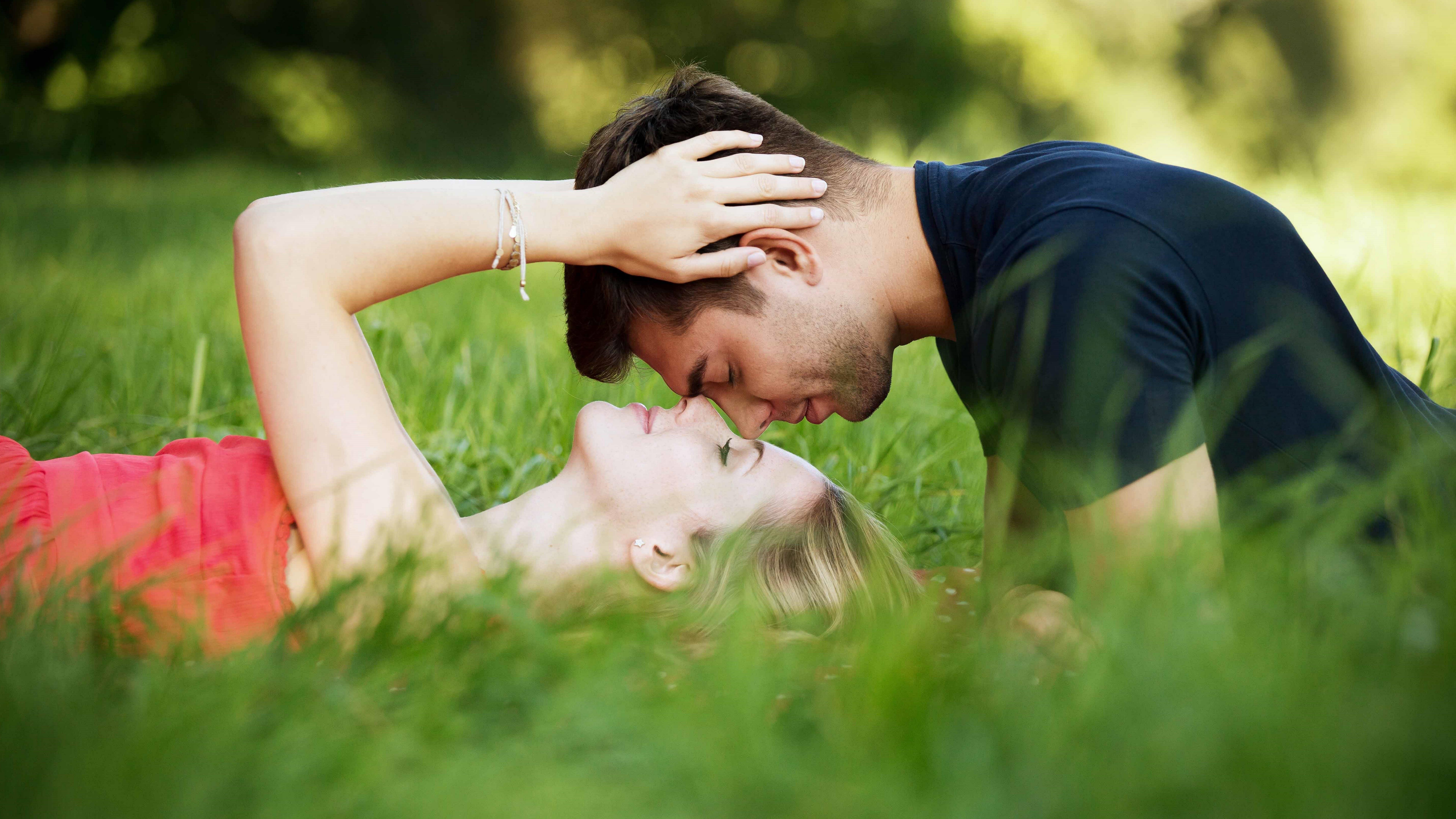 Stylish with romantic couple kiss on grass love wallpaper