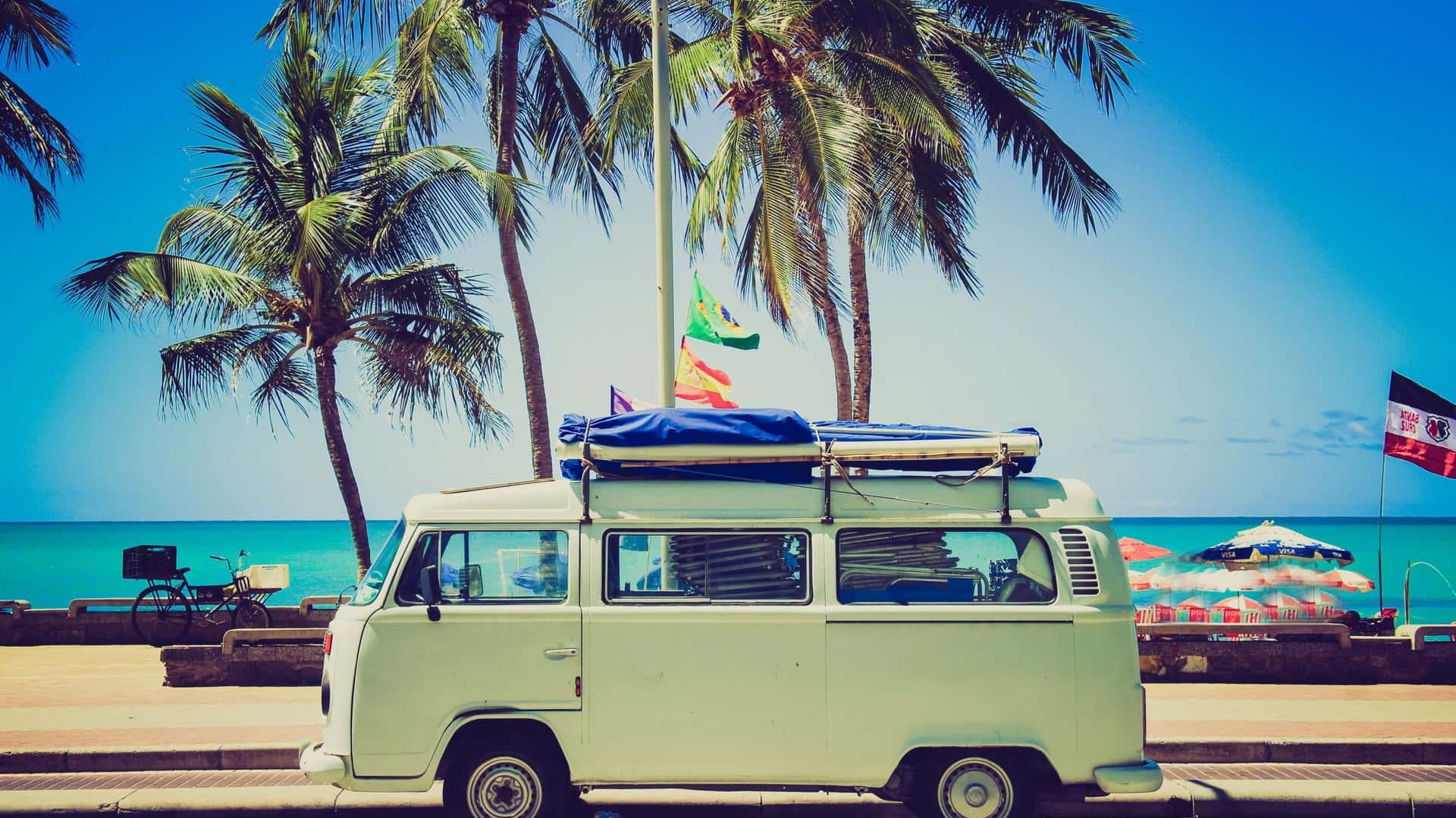 A Vw Bus Parked On The Beach With Palm Trees Wallpaper