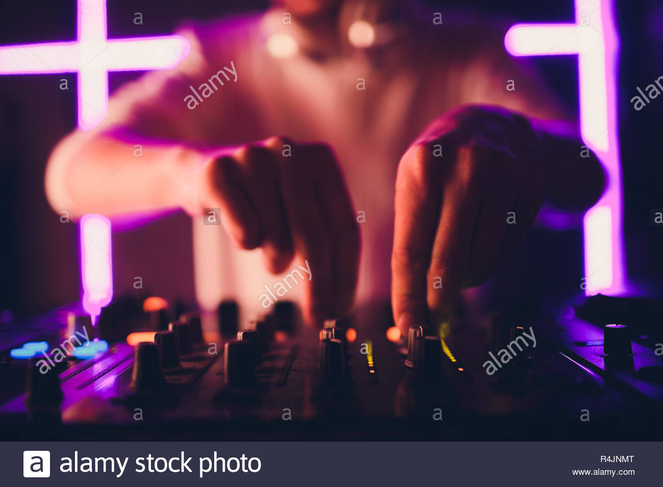 Dj Playing Music At Mixer On Colorful Blurred Background Stock