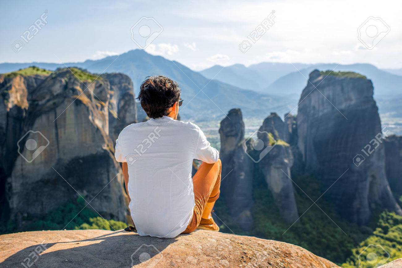 Well Dressed Man Sitting On The Rocky Mountain Beautiful Scenic