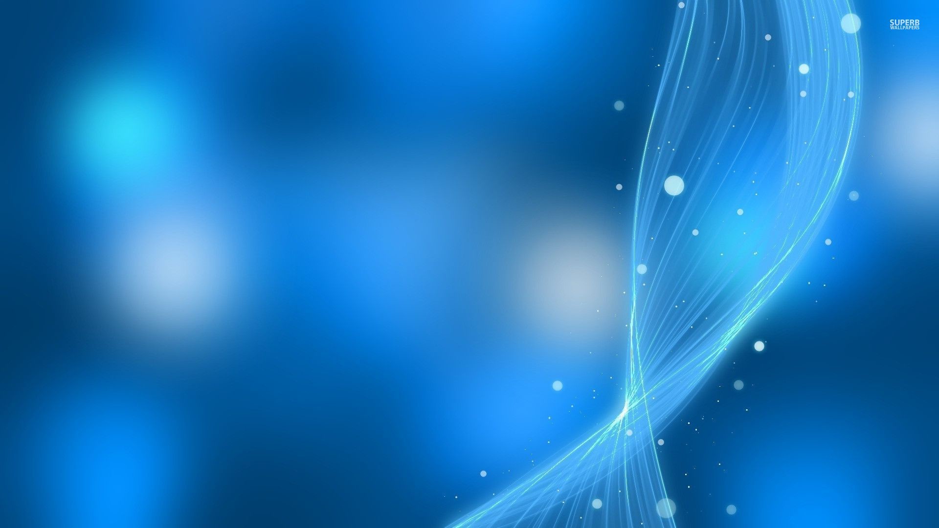 Abstract light blue background with glowing swirls and bokeh effect