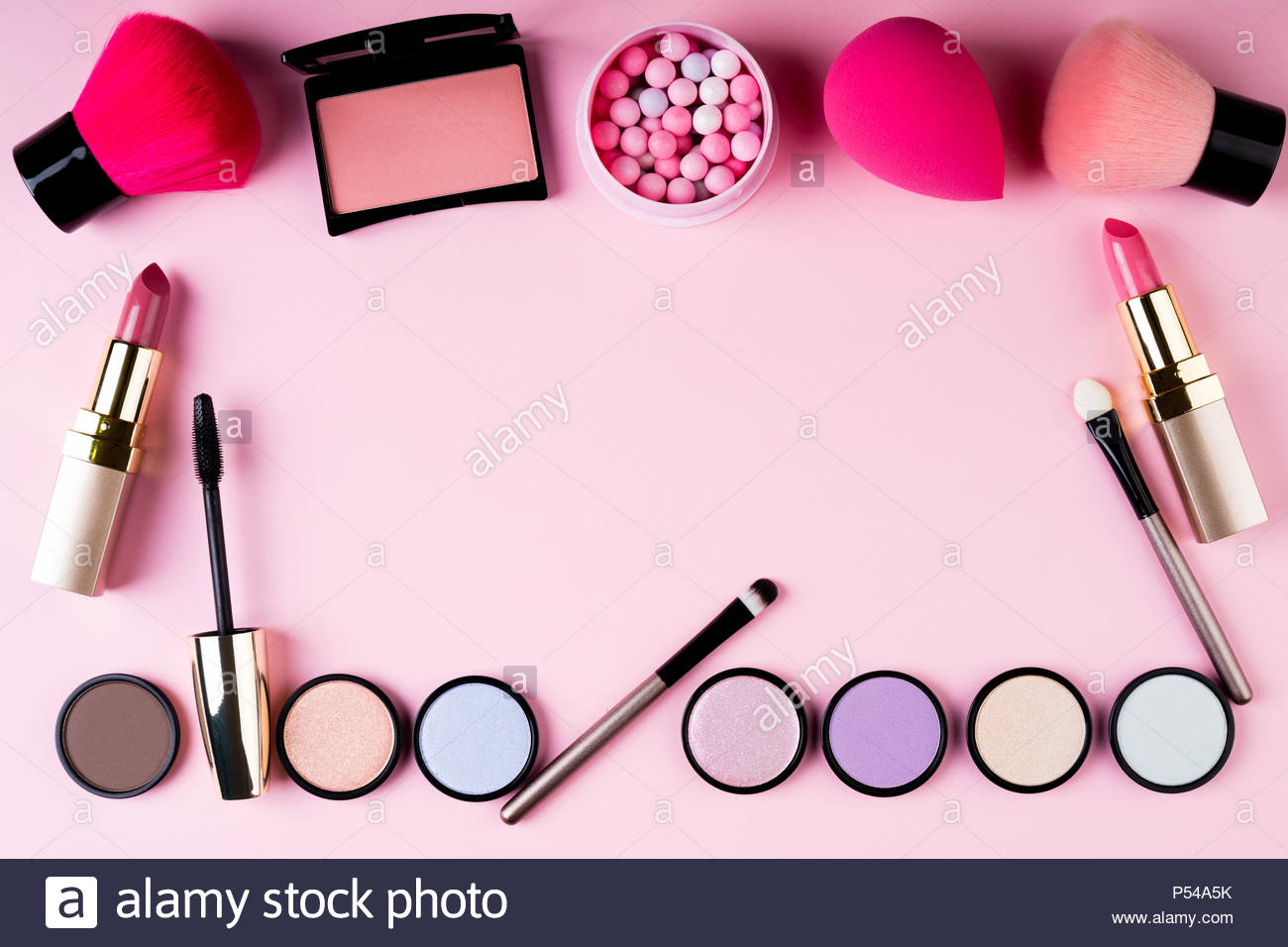 Frame Of Makeup Products And Decorative Cosmetics On Pink