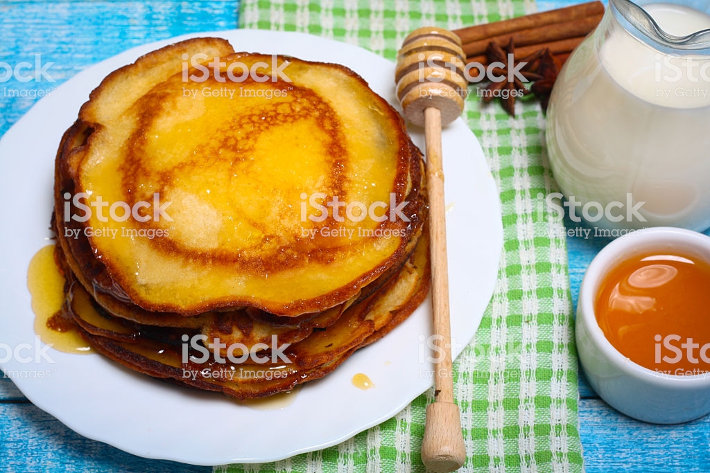 Sweet Pancakes With Honey On Wooden Background Stock Photo